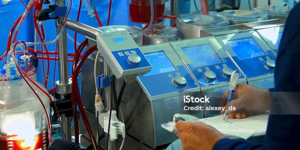 Doctor writes down Cardiopulmonary bypass machine data Doctor writes down Cardiopulmonary bypass machine data